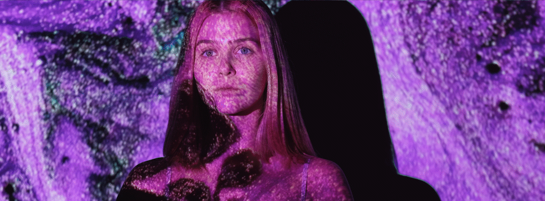woman in front of paint projector